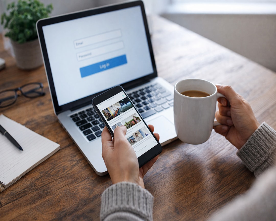 Checking a smartphone during a quiet morning workspace routine with laptop and coffee.